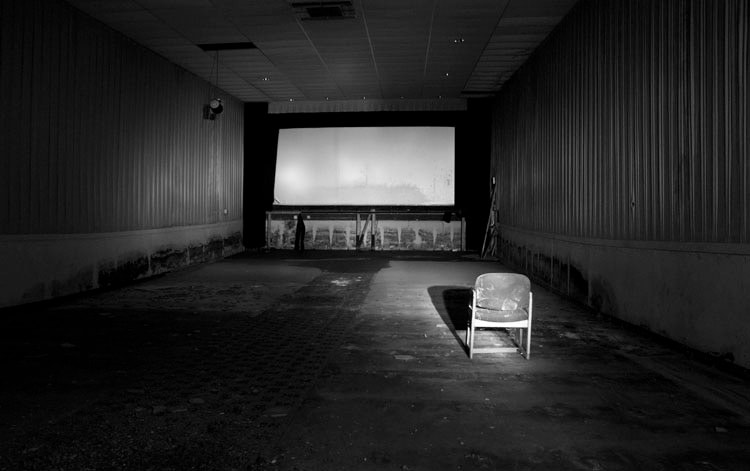 Empty theater interior with a single chair