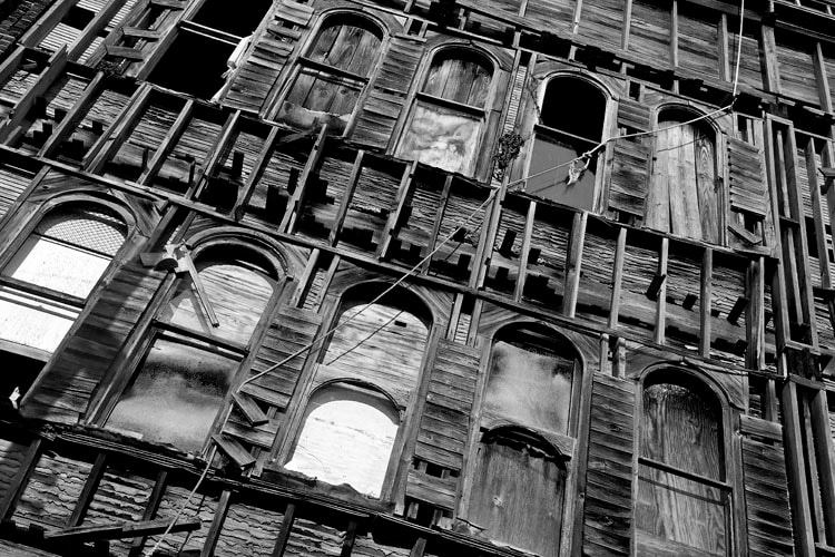 Weathered wooden facade with arched windows